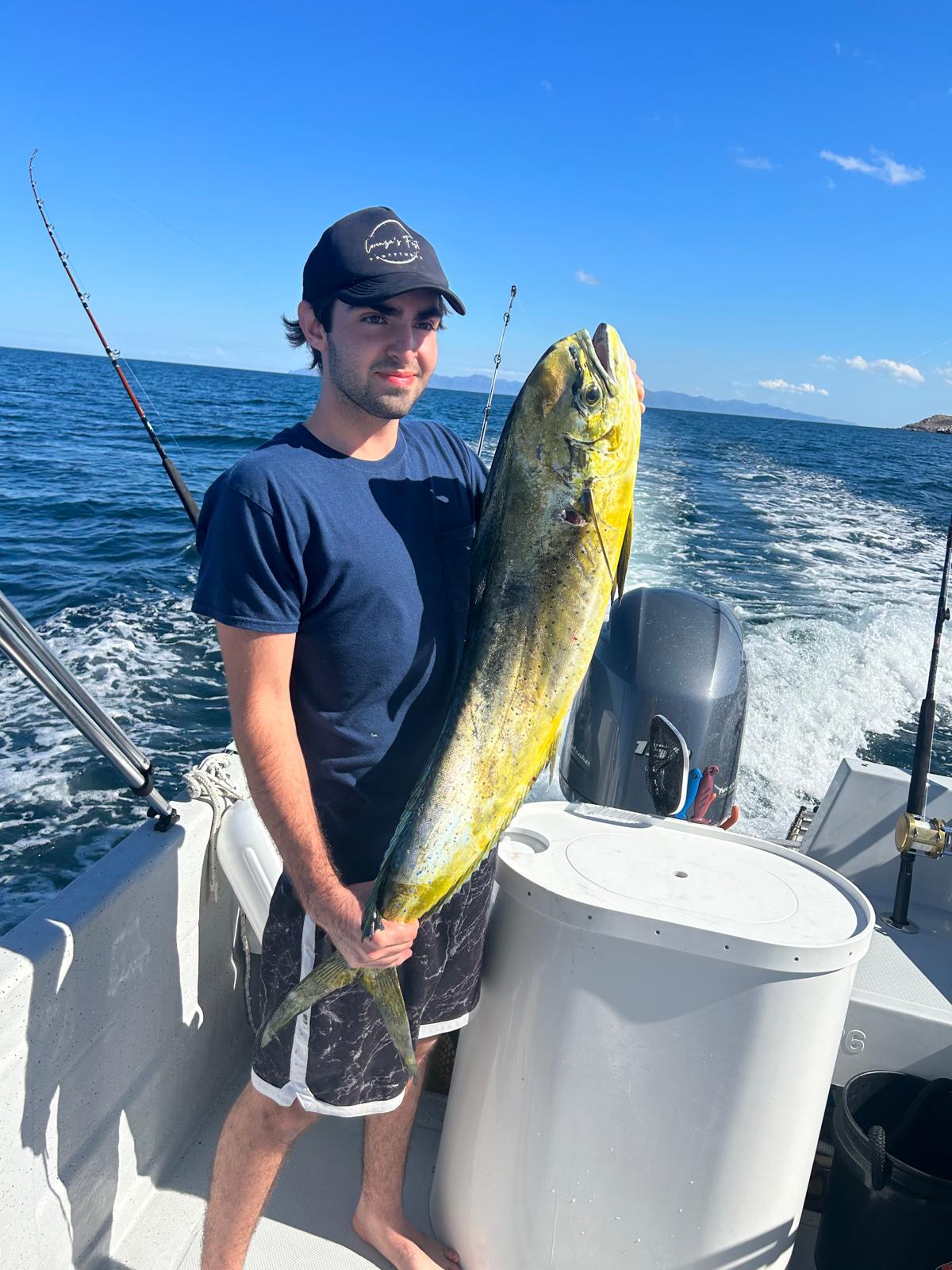 Angler holding a mahi-mahi caught on a Mareiros charter